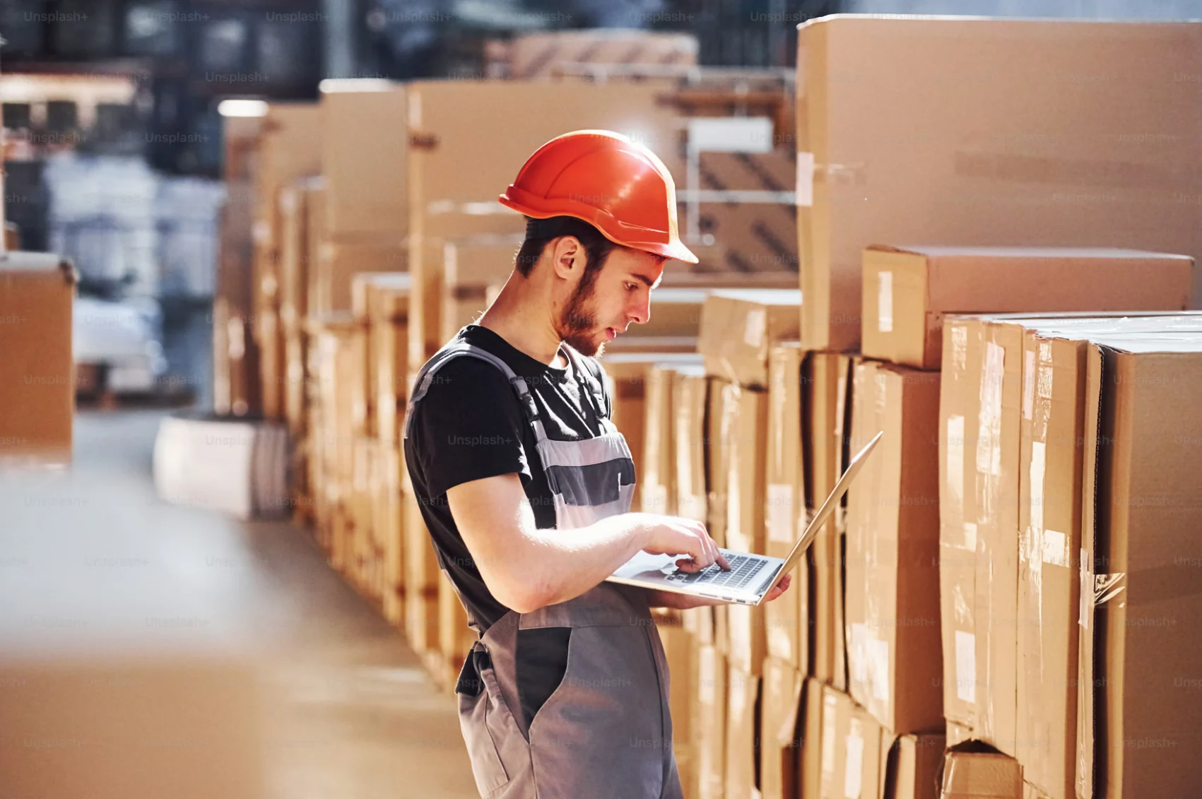 Man checking box while using laptop